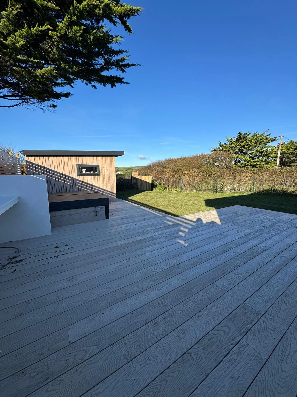 Garden office with grey composite decking and countryside views in North Devon