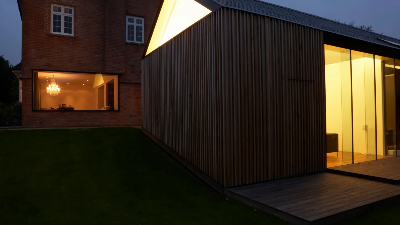 Stock photograph of a timber-clad house extension with full-height glazing