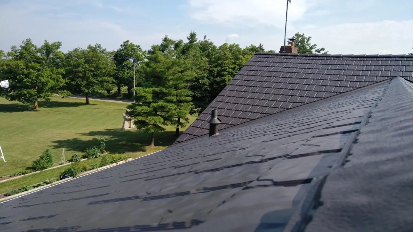 Stock photograph of a slate roof with ridge tiles and roof vents