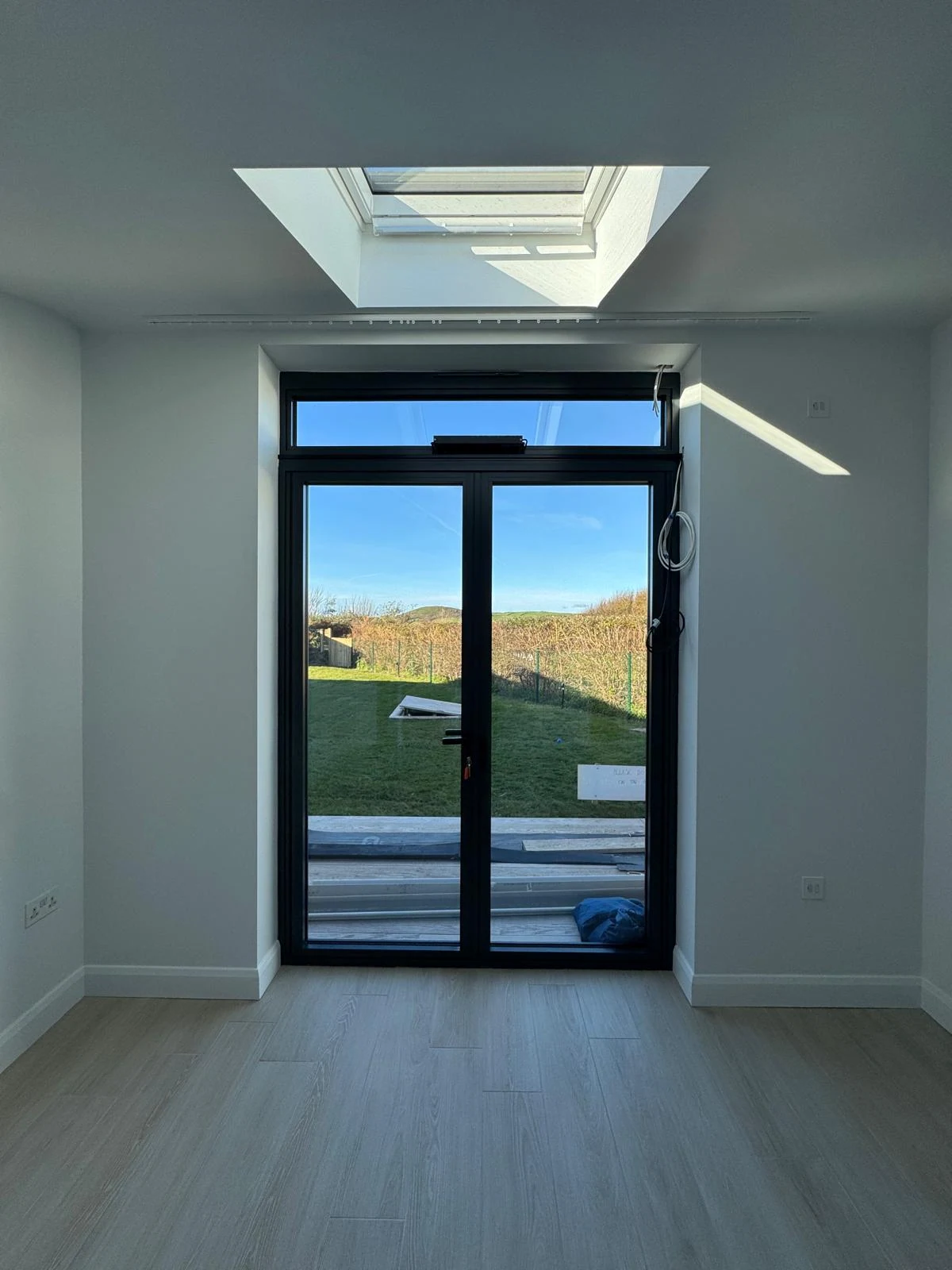New build room with roof lantern and glazed doors to the garden