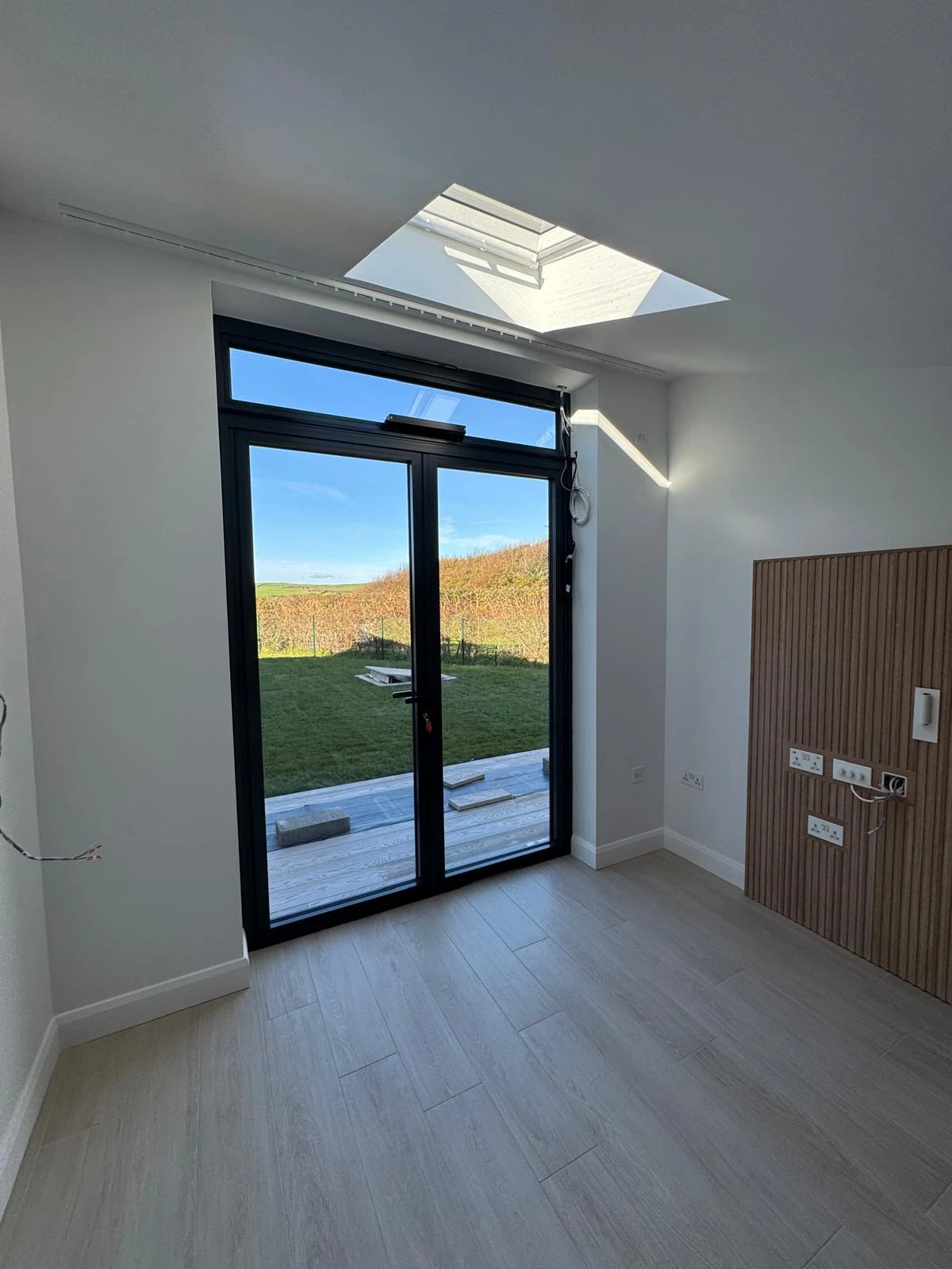 New build room with roof light and black double doors