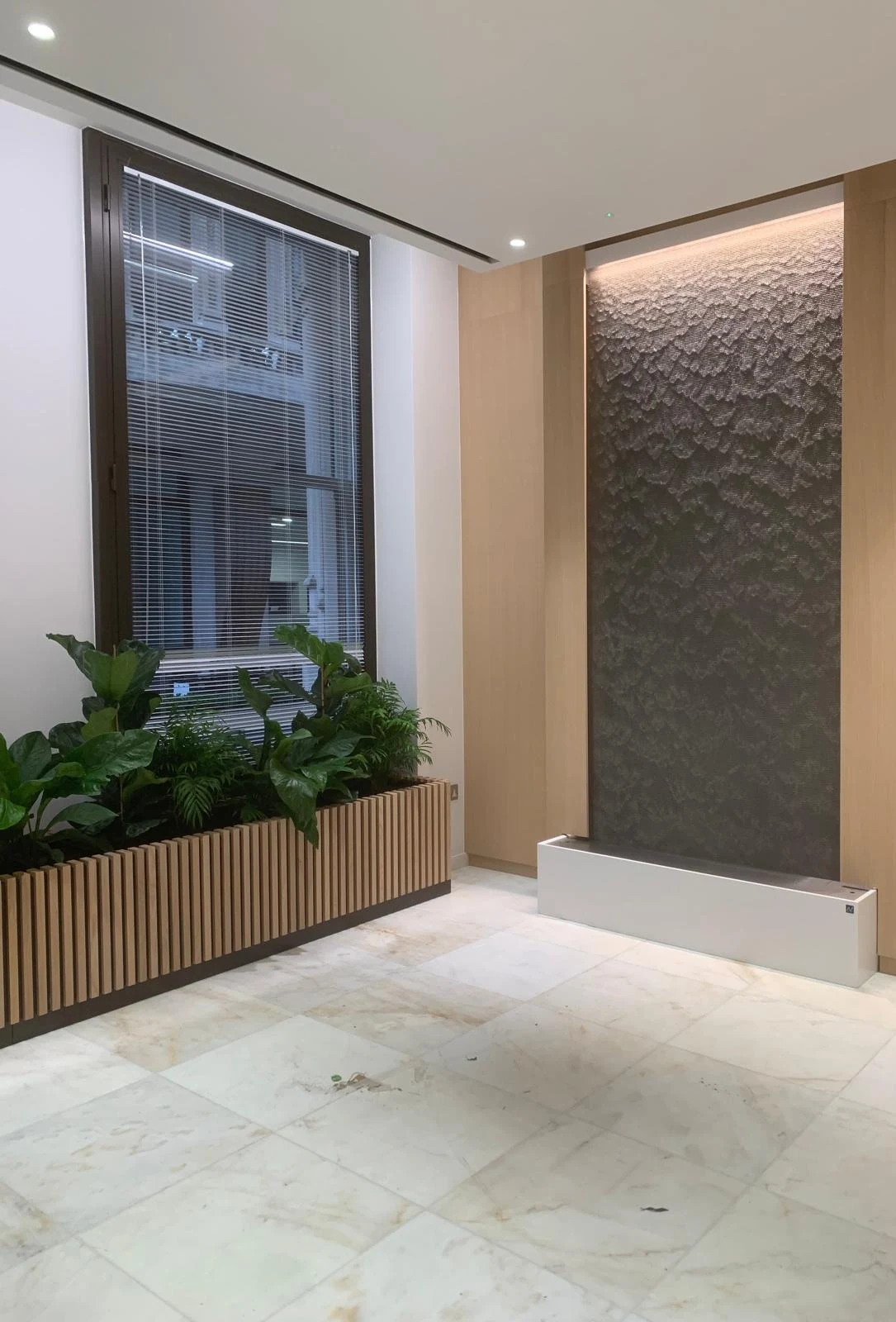 Timber planter and textured feature wall with recessed lighting