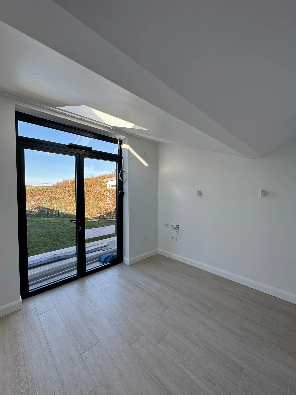 New build bedroom with roof light and garden doors