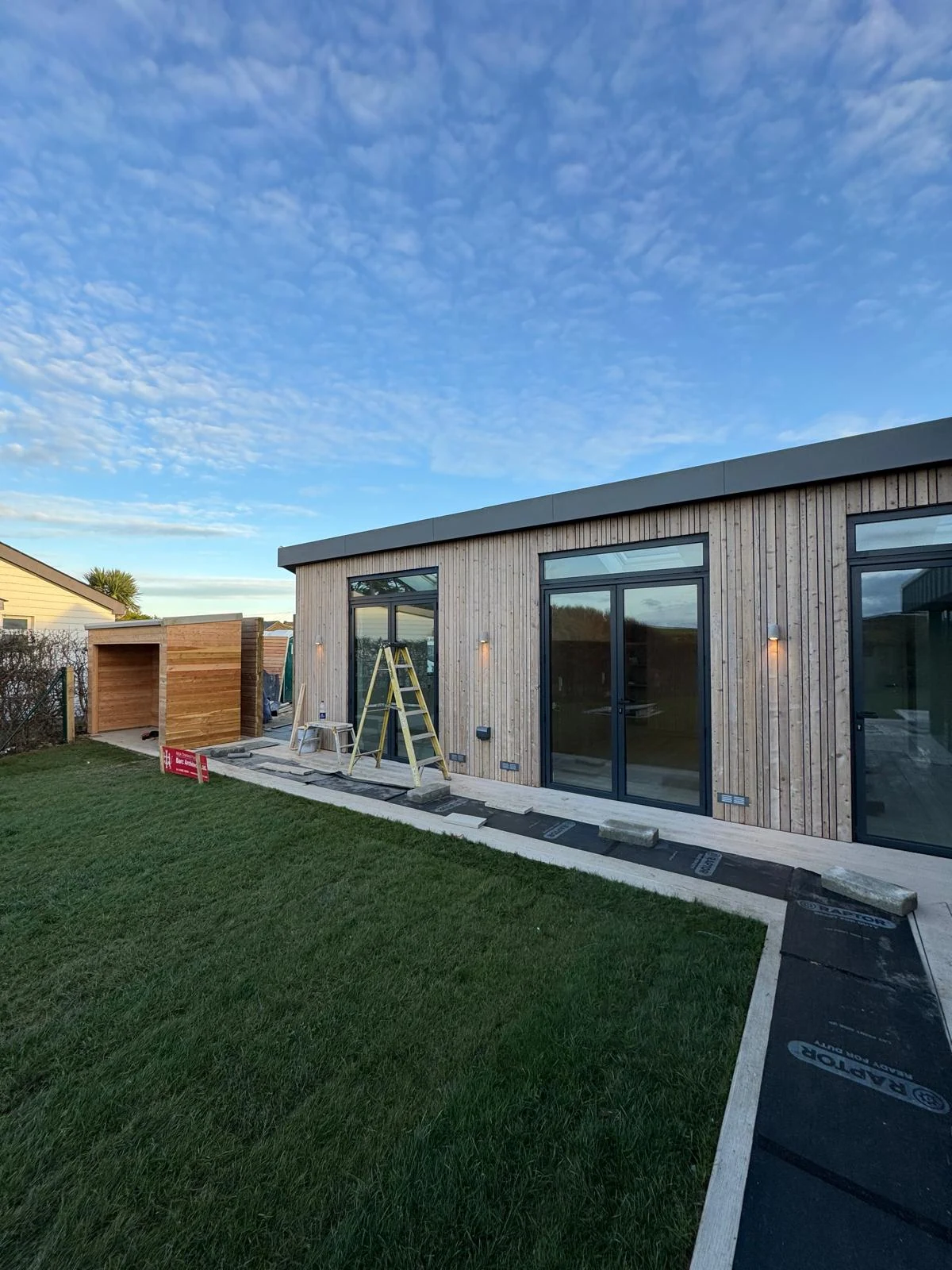 Timber-clad single-storey new build with lawn in North Devon