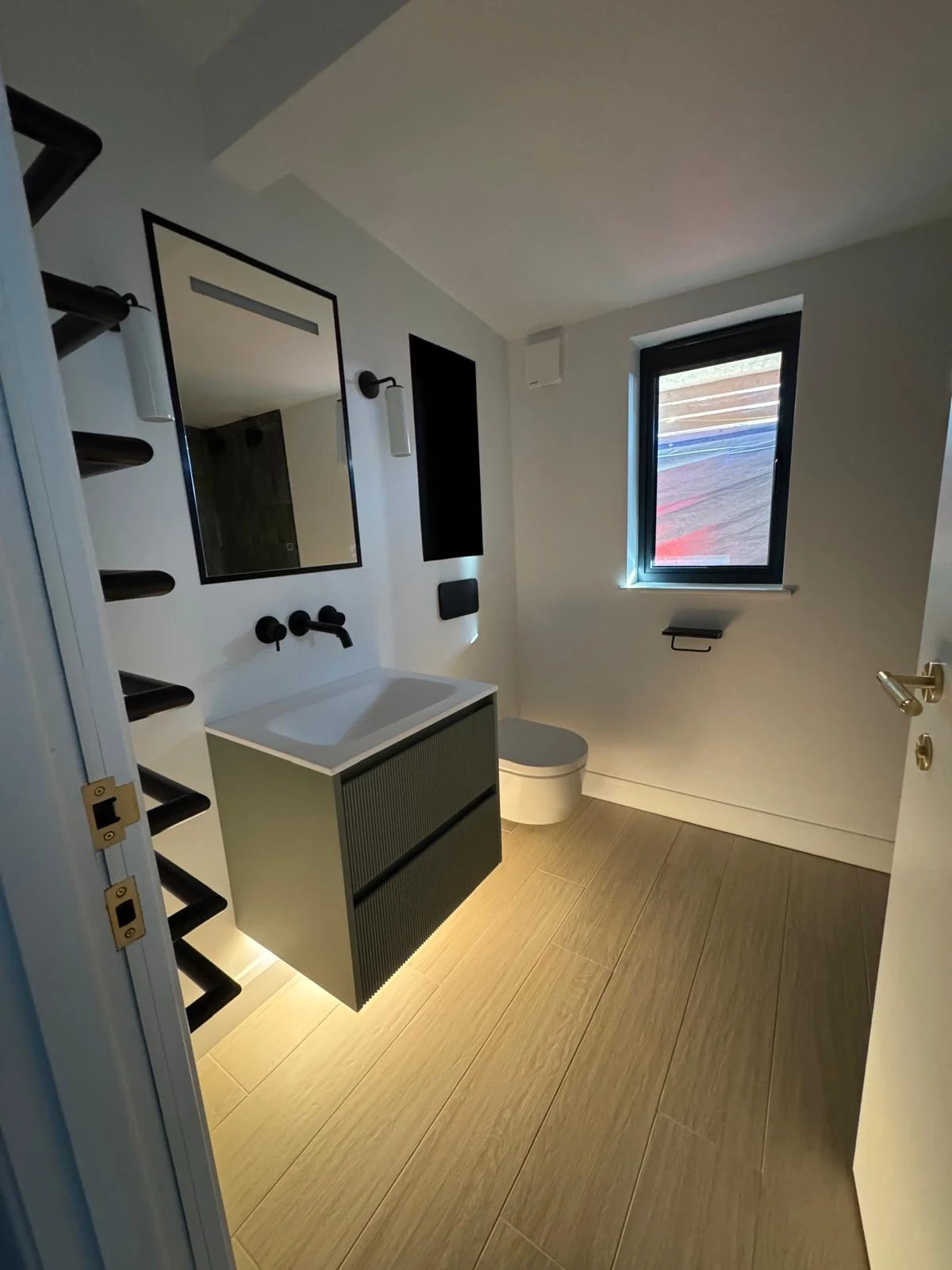 New build ensuite with backlit vanity and black fittings