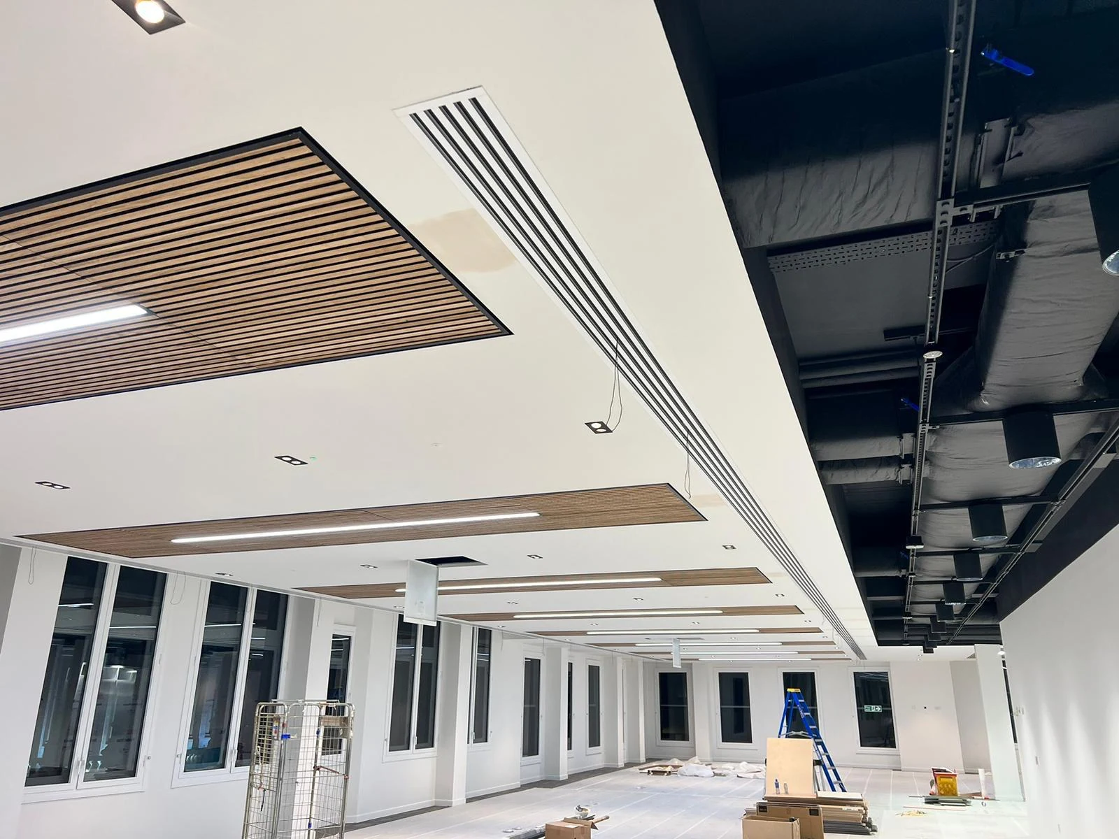 Timber slatted ceiling detail fitted by carpenters in an open-plan space