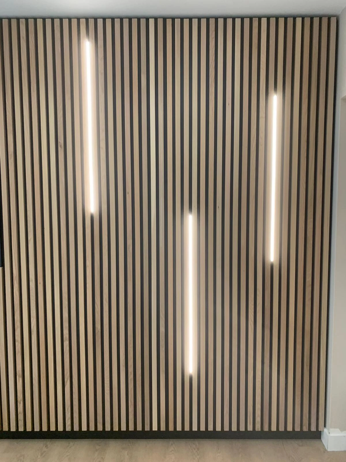 Vertical timber slat wall with integrated LED lighting