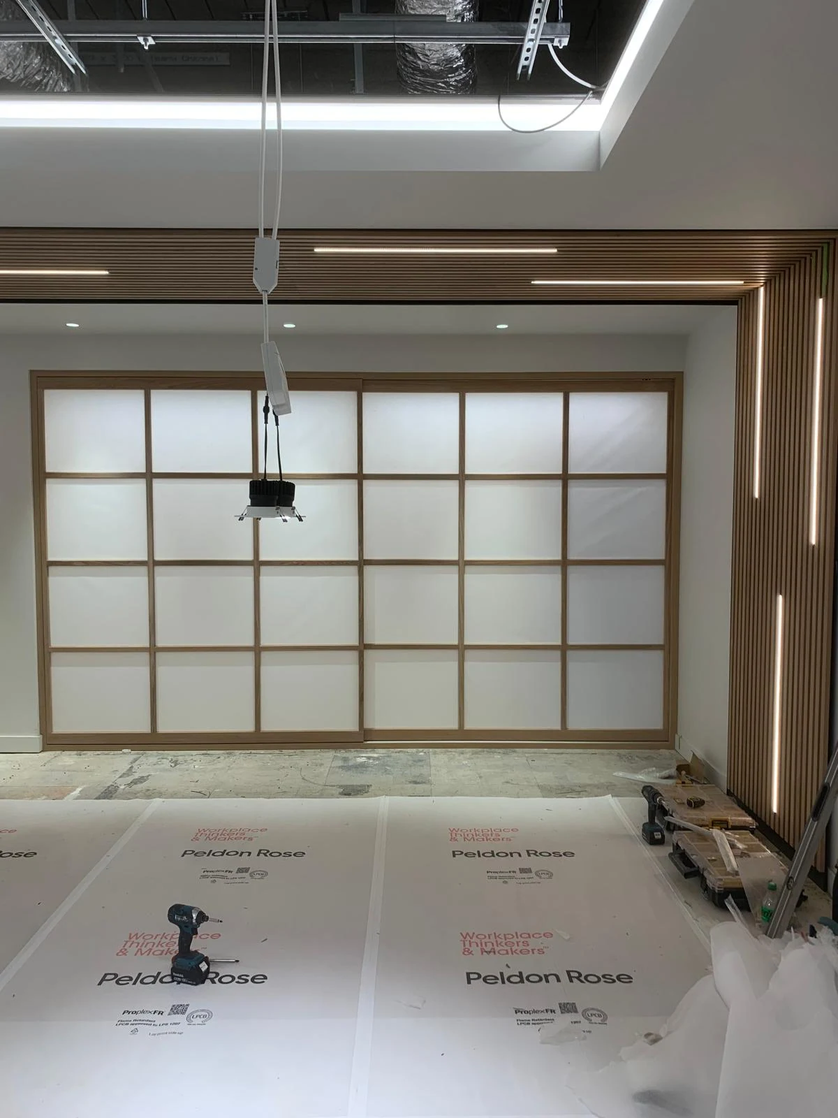 Shoji-style timber screen panels during installation
