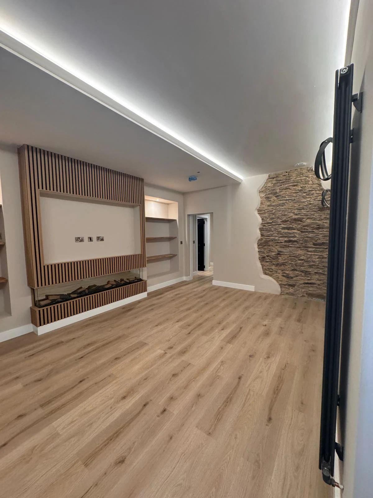 Bespoke media wall and shelving joinery in a large living space